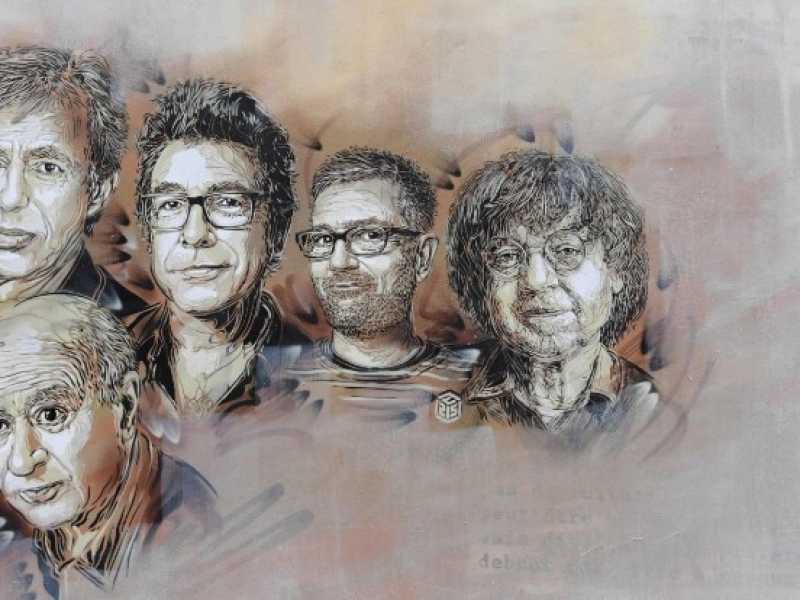 I ritratti di Georges Wolinski, Bernard Verlhac, Stephane Charbonnier e Jean Cabut su un muro di rue Nicolas Appert (foto LaPresse)