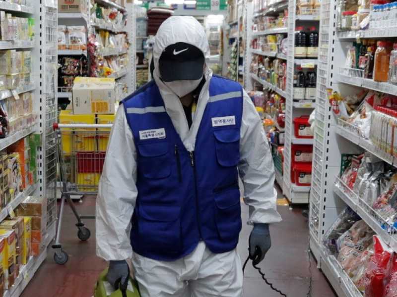 Un lavoratore in un supermercato di Seul (foto LaPresse)