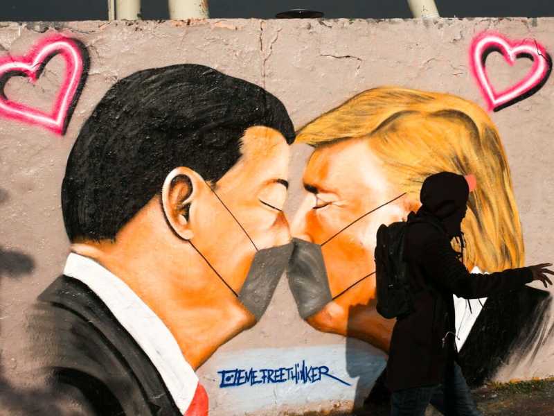 Un graffito con il ​​presidente degli Stati Uniti Trump, a destra, e il presidente cinese Xi Jinping che si baciano con le mascherine, nel parco pubblico Mauerpark a Berlino (LaPresse)