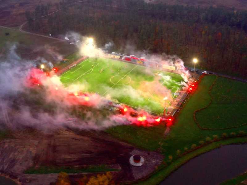 Lo stadio da 200 posti in mezzo ai campi in cui si sono svolte le battaglie dello scorso anno, con i fumogeni colorati lungo il campo <br />