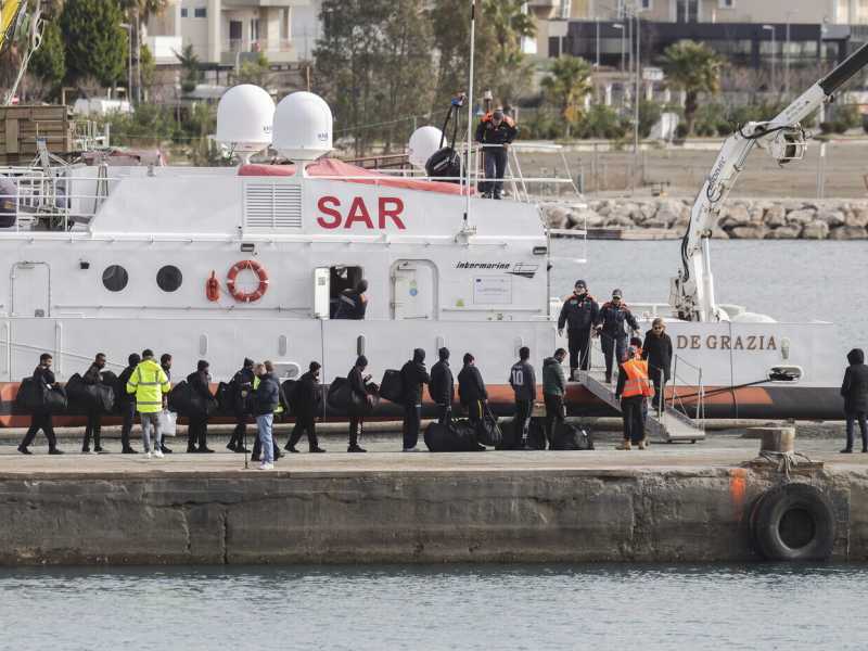 La Guardia costiera italiana si occupa del trasferimento dei migranti dai centri in Albania (AP Photo/Vlasov Sulaj)&nbsp;<br />