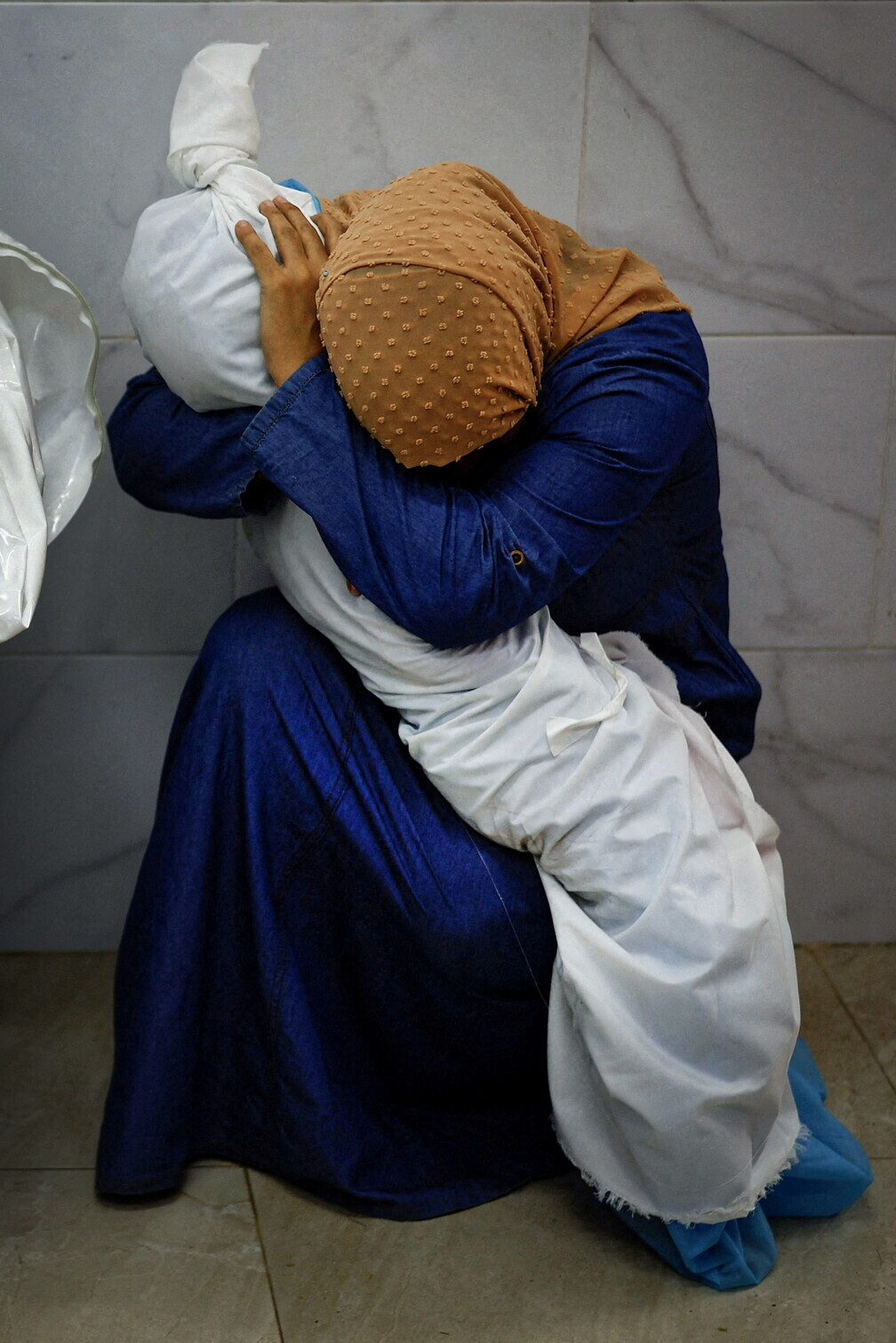 "A Palestinian Woman Embraces the Body of Her Niece", Mohammed Salem
