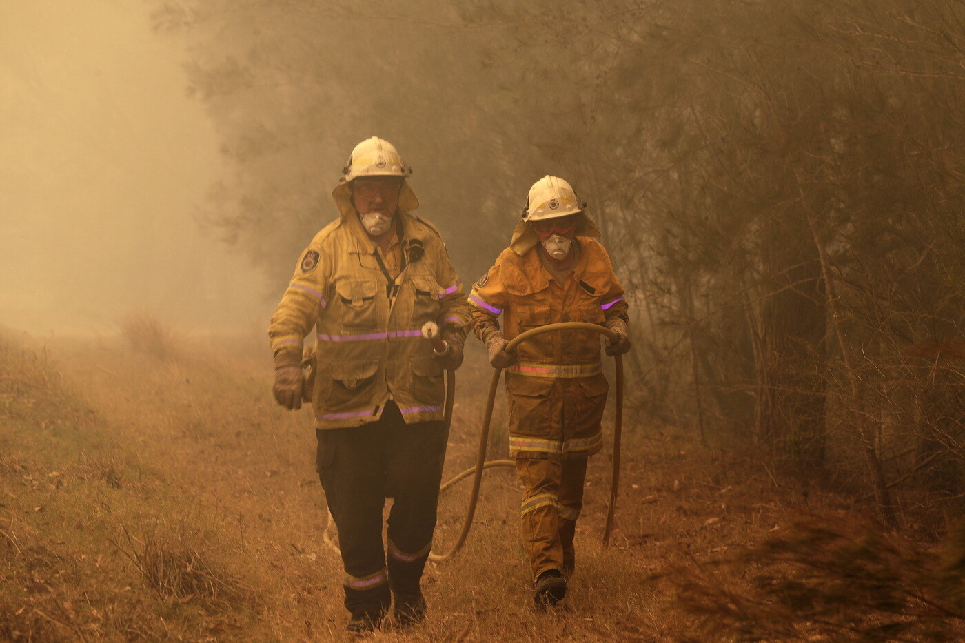 Due pompieri nell’incendio di Moruya, il 4 gennaio scorso. Scott Morrison ha richiamato circa tremila riservisti per far fronte all’emergenza (Foto Ap/Rick Rycroft)