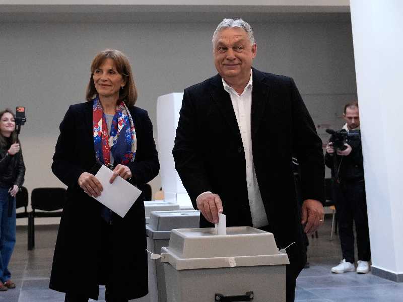 Hungary's Prime Minister Viktor Orban, right, and his spouse Aniko Levai cast their ballots at a polling station in Budapest, Hungary, Sunday, April 12, 2026. (AP Photo/Petr David Josek)